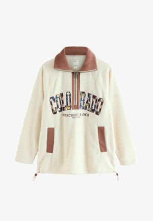 Krém színű fleece pulóver zipzáras gallérral, több színben készült "COLORADO" grafikával és barna részletekkel a zsebeknél és a gallérnál.