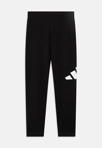 Leggings noirs en matériau doux avec un design ajusté, arborant un logo blanc imprimé sur le bas à gauche.