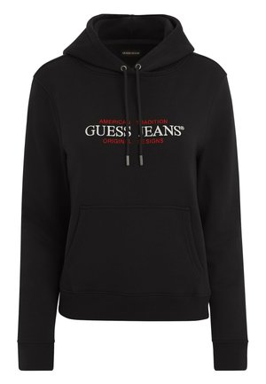 Črna kapuca z vrvico, sprednjim žepom in logotipom z napisom "GUESS JEANS" v belih in rdečih barvah. Narejena iz mehkega, teksturiranega blaga.