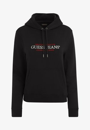 Black hoodie with drawstring, front pocket, and a logo featuring "GUESS JEANS" in white and red. Made from soft, textured fabric.