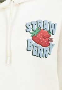 Cream-colored hoodie featuring a graphic design of a red strawberry and the text "STRAW BERRY" in blue and green. Texture appears soft.