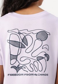 Light purple cotton t-shirt featuring a black abstract graphic design on the back, with smooth lines and circular patterns.