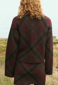 Wool blend, plaid jacket in deep burgundy and dark green, featuring a relaxed fit, wide sleeves, and soft texture. Back view shown.