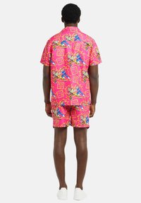 Pink short-sleeve shirt and matching shorts featuring a colorful graphic print with abstract designs and bold outlines.