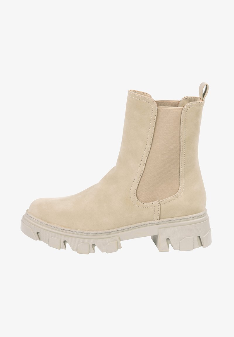 Botte Chelsea en daim beige avec semelle épaisse texturée, panneaux latéraux élastiques et languette à l'arrière.