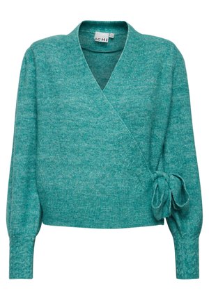 Pull-over en teal, fabriqué dans un matériau doux, avec un col en V, des manches longues et un accent noué sur le côté. Finition texturée sur l'ensemble.