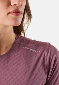 Lightweight, purple athletic shirt with a textured grid pattern, featuring the "SWEDEMOUNT" logo in silver near the shoulder.