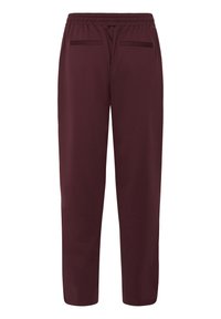 Burgunderfarbene Jogginghosen mit einem elastischen Bund, zwei Gesäßtaschen und einem schmalen Bein-Design; hergestellt aus weichem, atmungsaktivem Material.
