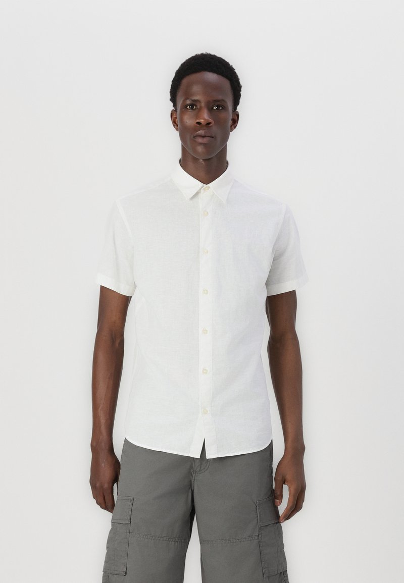 Short-sleeve white button-up shirt made of lightweight fabric, featuring a standard collar and clear button closure, paired with grey cargo shorts.