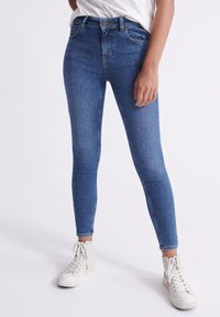 Blå denim skinny jeans med hög midja, som har fem fickor, knappstängning och lätt blekning i en slät textur.