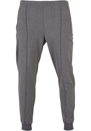 Pantaloni de sport gri, dintr-un material texturat, cu o talie elastică, manșete cu nervuri și două buzunare laterale cu cusături verticale.