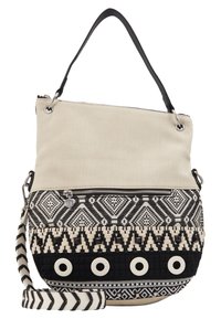 Torba na ramię z płótna i tkaniny, w beżowej górnej części, czarno-białym wzorze w dolnej części, z zapięciem na zamek u góry oraz regulowanym paskiem w paski.