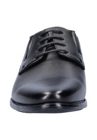 Zwarte leren heren schoenen met een glad oppervlak, ronde neus en zes gaatjes voor veters. Voorzien van een lage, duurzame zool.