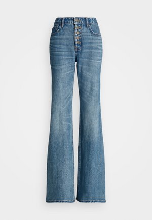 Høyt midjebelte blå denim flared jeans med knappeåpning og frontlommer. Har et tettsittende parti og vide ben med råkant.