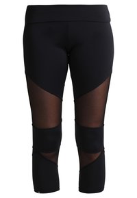 Leggings noirs avec des panneaux en résille et un design de découpes géométriques. Fabriqués dans un tissu extensible, ils arrivent au mollet et ont une taille haute.