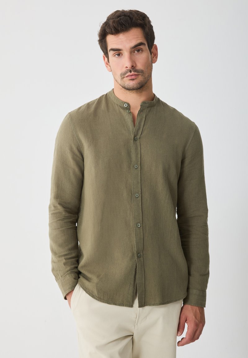 Olive green long-sleeve button-up shirt with a mandarin collar, made of lightweight fabric, features a subtle texture and rounded hem.