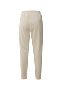 Beige sweatpants met een taps toelopend ontwerp, elastische tailleband en een gladde, zachte textuur. Heeft geen zichtbare hardware of patronen.