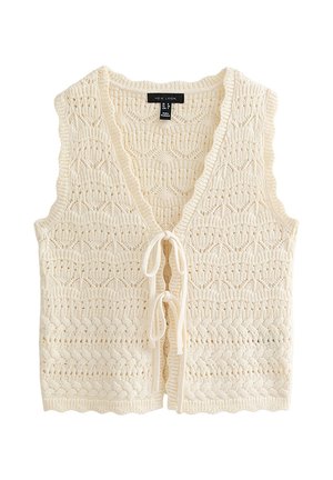 Veste sans manches en tricot couleur crème avec col en V et deux fermetures à nouer à l'avant, présentant un motif texturé en dentelle et tricot torsadé.