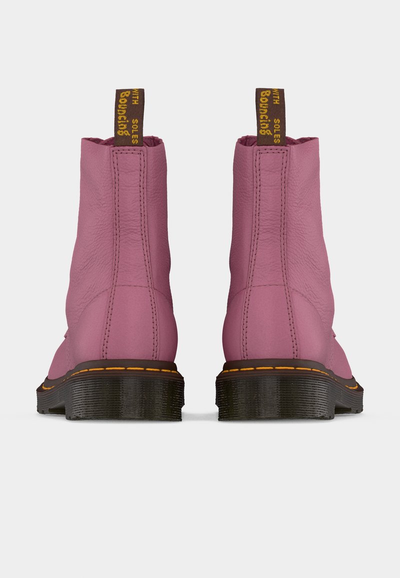 Pair of pink leather ankle boots with black chunky soles and yellow stitching, back view with branded pull tabs.