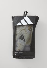 Black mesh bag containing white and gold goalkeeper gloves, featuring a white Adidas logo on top and "Football/Soccer" label at the bottom.