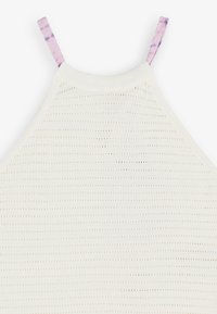 White knitted halter top with a textured pattern, featuring light purple tie-dye straps. The fabric has small, evenly spaced holes.