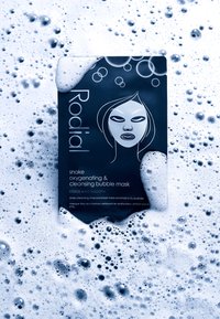 Black foil packet featuring a white graphic of a face. Text states "Rodial snake oxygenating & cleansing bubble mask" in white. Bubbles surround.