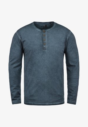 Koszula henley z długim rękawem w zgaszonym niebieskim kolorze, wykonana z miękkiego materiału. Posiada okrągły dekolt oraz pięć brązowych guzików. Prosty wzór.