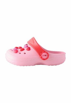 Pink plastic clogs with a red strap, featuring decorative heart-shaped accents and ventilation holes. Lightweight, curved design.