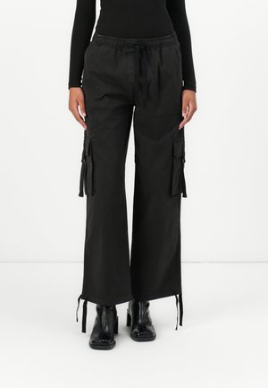 Tommy Jeans ELASTICATED PANT - Hlačami s stranskimi žepi - black