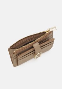 Brown leather wallet with a front flap, zip closure, and gold hardware. Features multiple card slots and a textured outer surface.