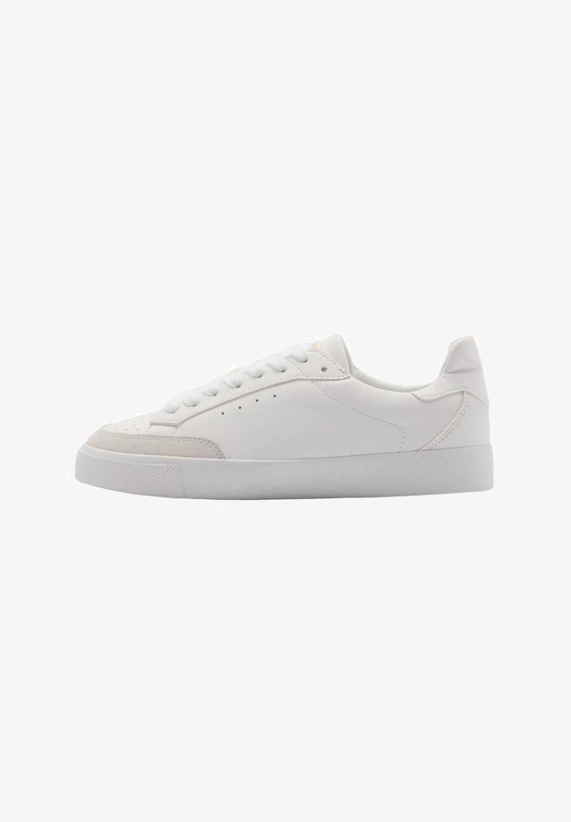 White sneakers with a smooth leather upper, featuring a rounded toe, flat laces, and a textured rubber sole. Minimalist design with subtle details.