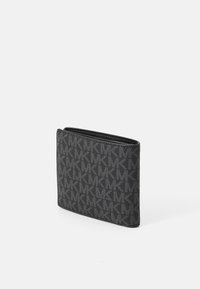 Portafoglio bifold Michael Kors in nero e grigio con motivo ripetuto del logo MK e piccolo nome del marchio metallico sul davanti, su sfondo bianco.