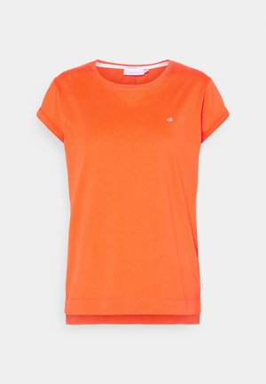 Bright orange short-sleeve T-shirt with round neckline, small white "ck" logo on the chest, and layered hem detail.