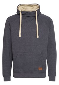 Sweat à capuche en tissu gris foncé avec un intérieur beige doux, doté d'une poche kangourou et de cordons beiges. Étiquette en cuir à l'ourlet.