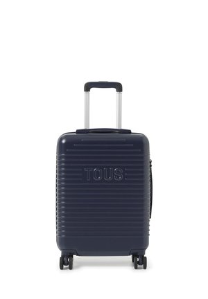 Valigia rigida blu scuro con manico telescopico e quattro ruote, con scanalature orizzontali e la scritta "TOUS" in rilievo sulla parte anteriore.