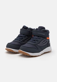 Blue high-top children's shoes with a Velcro strap, white stitching, and a brown rubber sole. Features a padded collar for comfort.