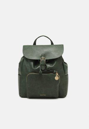 Dark green leather backpack with front zip pocket, flap closure with buckle, side pockets, and top handle on plain background.