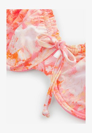 Haut de bikini floral en rose, orange et blanc avec des bords froncés et un détail nœud. Tissu lisse avec un motif vibrant.