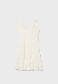 White lace dress with spaghetti straps, featuring a textured surface and flared hemline, has a fitted bodice and soft draping.