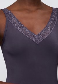 V-neck camisole in dark gray, featuring lace trim along the neckline and a smooth, fitted texture throughout the garment.