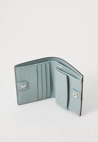 Light blue leather wallet with a textured finish, featuring multiple card slots, a snap closure, and contrasting dark edges.