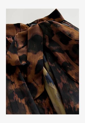 Printed fabric featuring warm brown, black, and gold tones with a soft, textured surface. Includes a prominent tied waist detail.