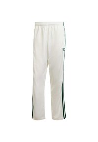 Vita atletiska byxor med gröna sidostråkar. Tillverkade av slät, lättviktsmaterial med resårmidja och adidas-logotyp på höften.