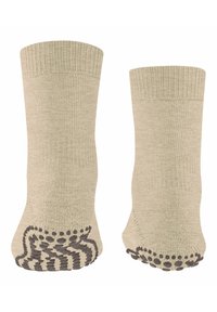 Beżowe skarpetki bawełniane z prążkowanym ściągaczem, z antypoślizgowym wzorem w brązowym kolorze na podeszwach, prezentujące teksturowaną powierzchnię.