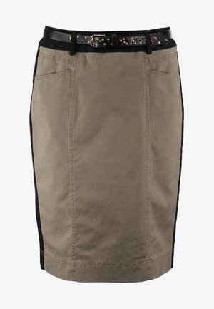 Woman wearing a black button-up shirt, khaki knee-length skirt with black stripe, black tights, black ankle boots, and holding a black clutch.