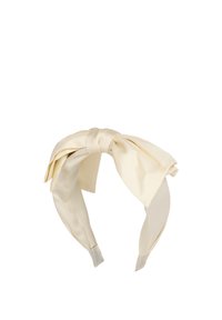 Satin headband in ivory with a large bow detail on the front, featuring smooth texture and wide straps.