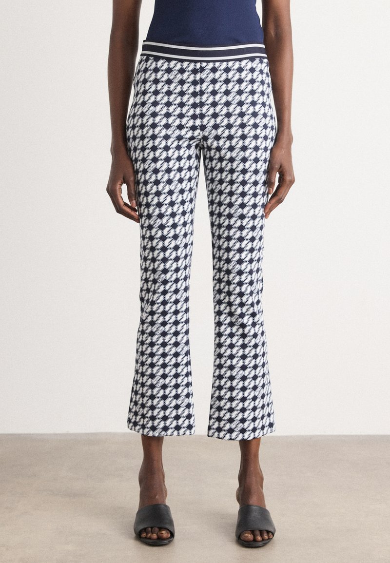 Marineblauwe en witte gebloemde cropped broek met een aansluitende tailleband en een uitlopende zoom, gemaakt van lichtgewicht stof. Draag het met zwarte instappers.