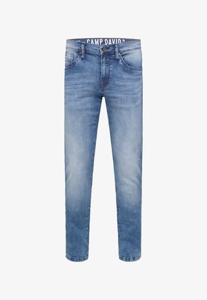 Light blue denim jeans feature a straight-leg design with a slightly faded texture, five pockets, and a branded waistband.