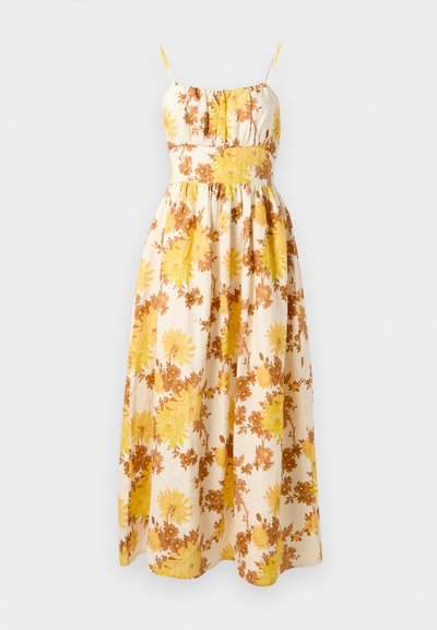 Kvetinové maxi šaty s žltými a hnedými kvetmi na krémovom pozadí, s tenkými nastaviteľnými ramienkami a zberaným živôtikom.