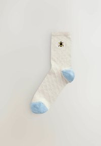 Lichtbeige sok met een ruitpatroon, blauwe hiel- en teenaccenten en een geborduurd bijenontwerp. Zachte textuur maakt het geheel af.